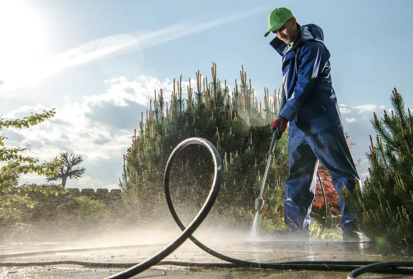 A worker washing garden floor