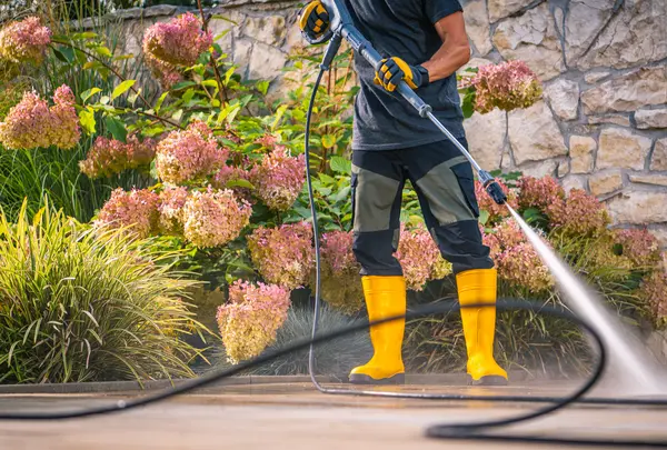 Js Pristine worker using pressure washing to clean patio