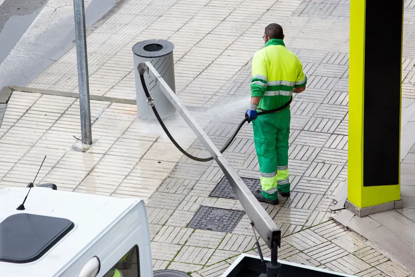A cleaner pressure washing sidewalks