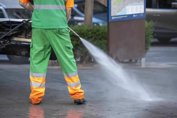 A cleaner washing park floor using pressure washing