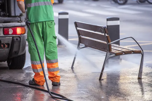 A worker pressure washing san dimas city street