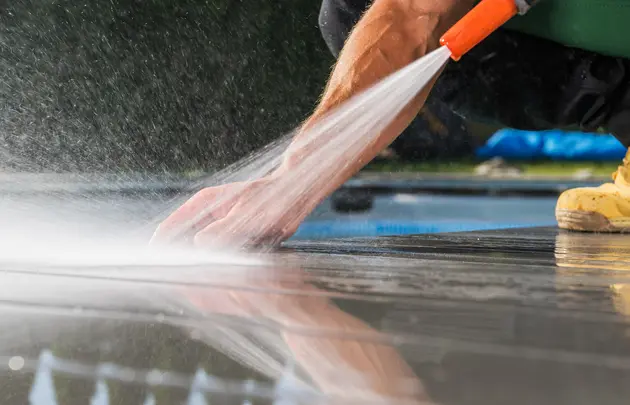 Js pristine worker cleaning patio poolside deck