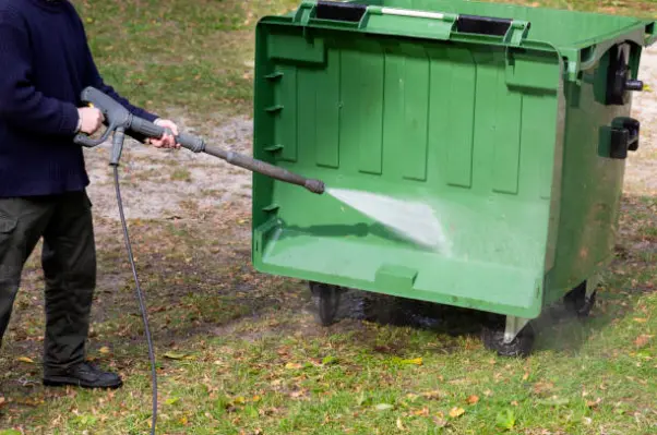 Cleaning garbage can with pressure washing tool