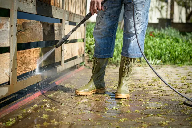 Pressure washing outside of a house