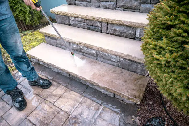 Washing outside dirty stairs with pressure washing tool
